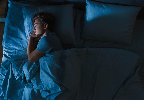 man in bed alone without wife at night